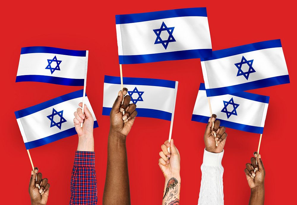 Hands waving flags of Israel