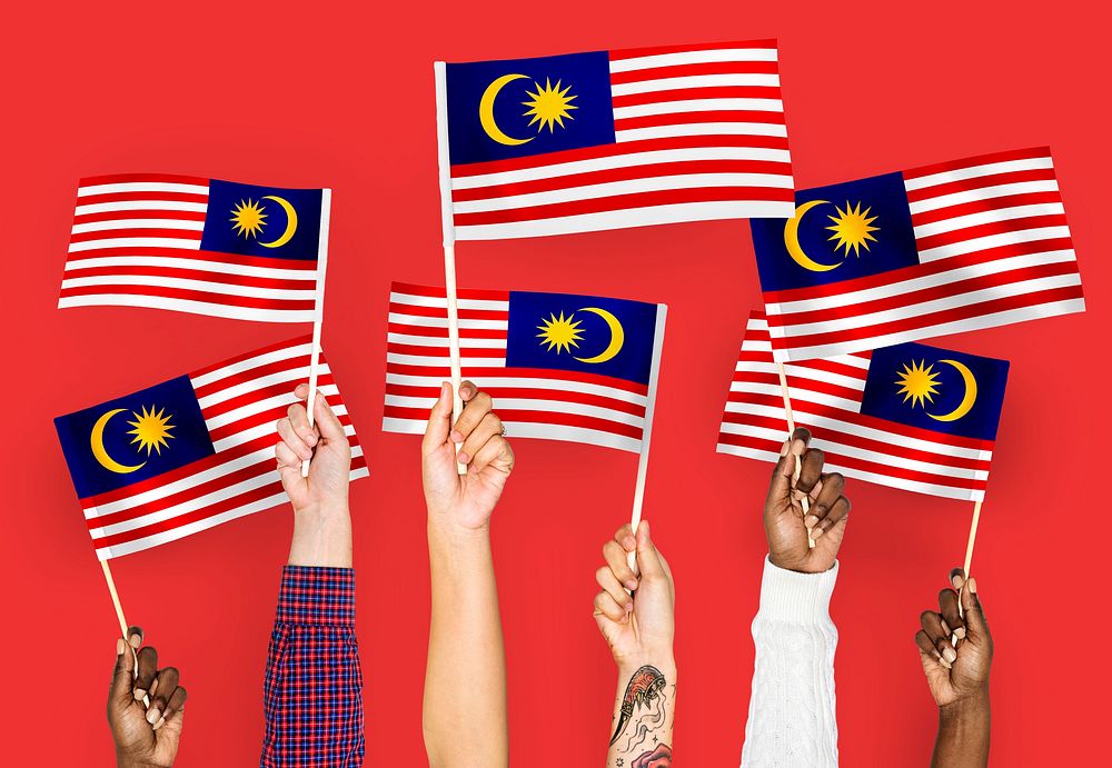 Hands waving flags of Malaysia