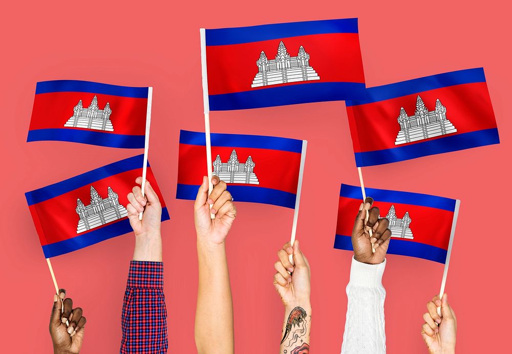 Hands waving flags of Cambodia