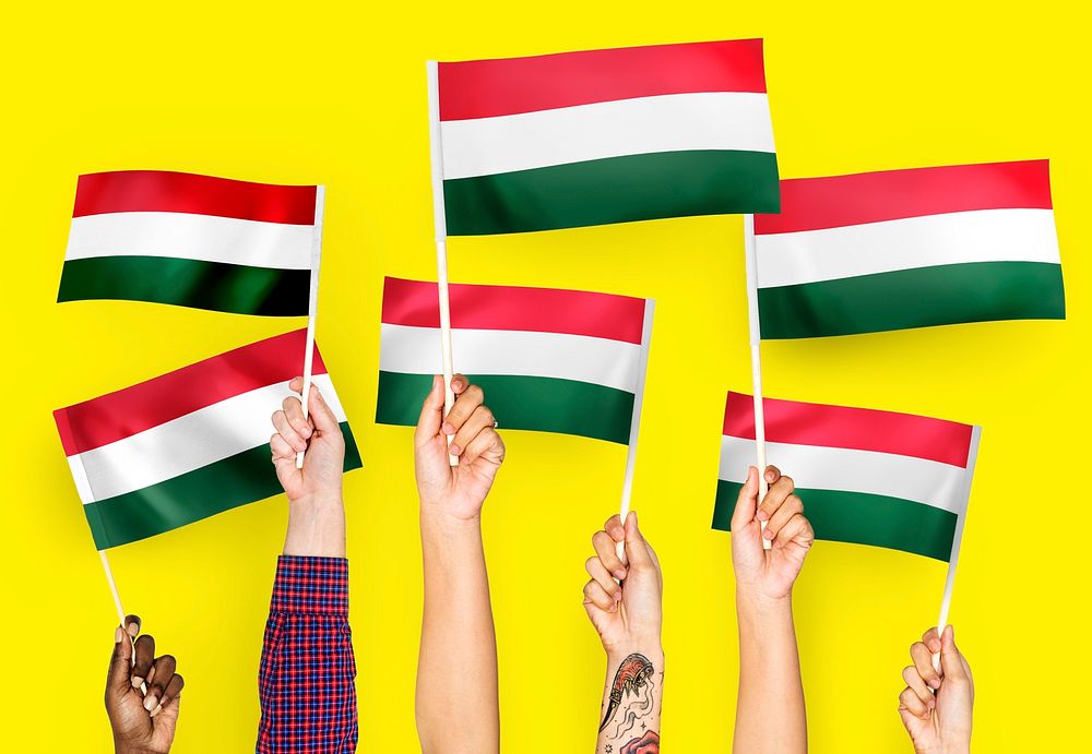 Hands waving flags of Hungary