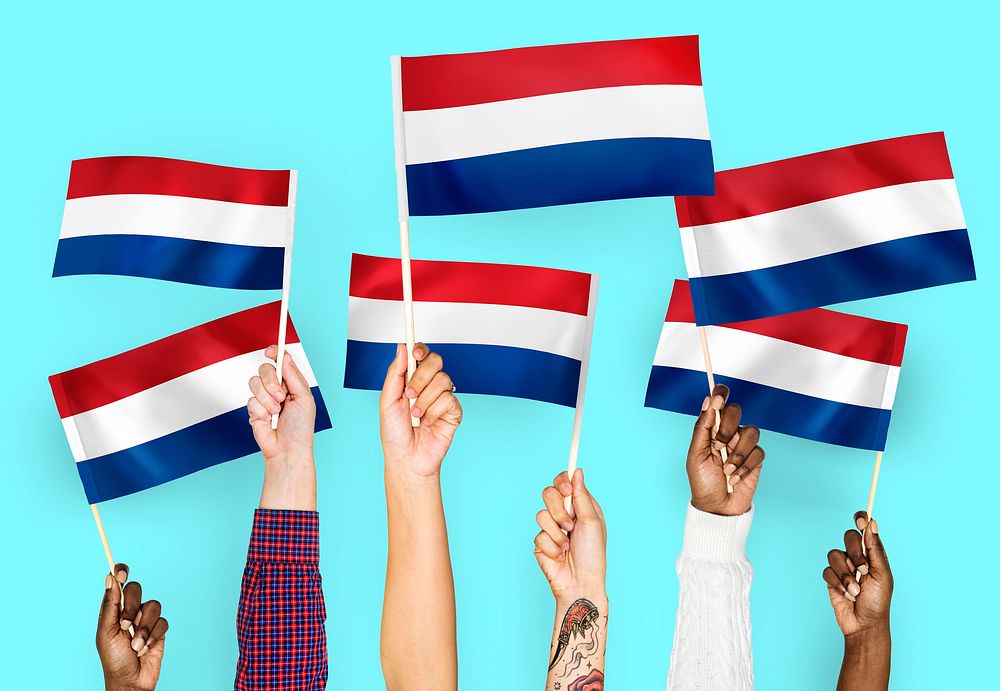 Hands waving flags of the Netherlands