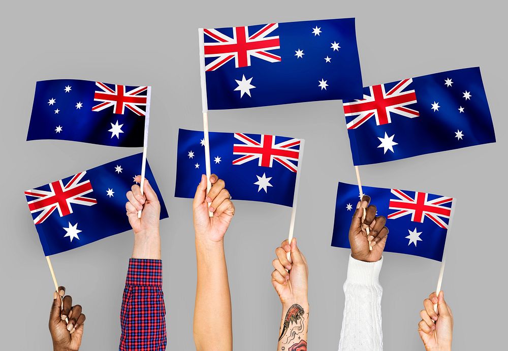 Hands raising Australia national flags
