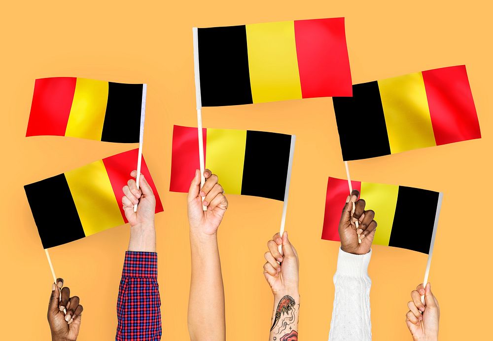 Hands waving the flags of Belgium