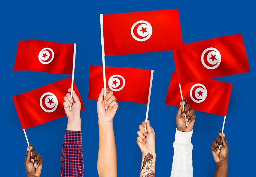 Hands waving the flags of Tunisia