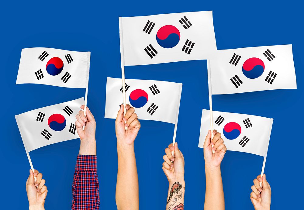 Hands waving the flags of South Korea