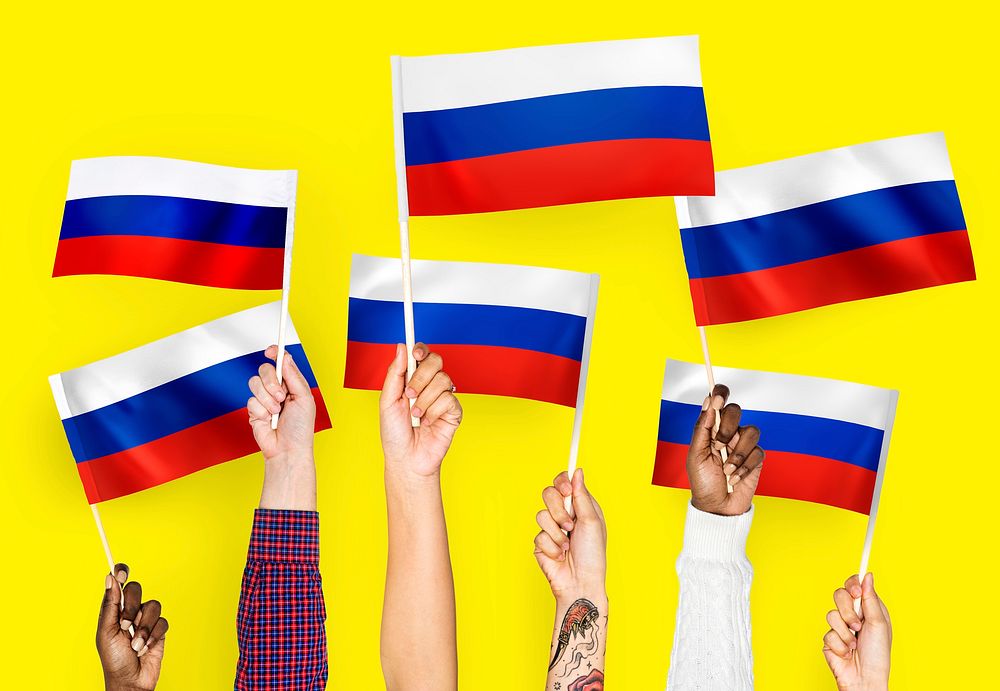 Hands waving the flags of Russia