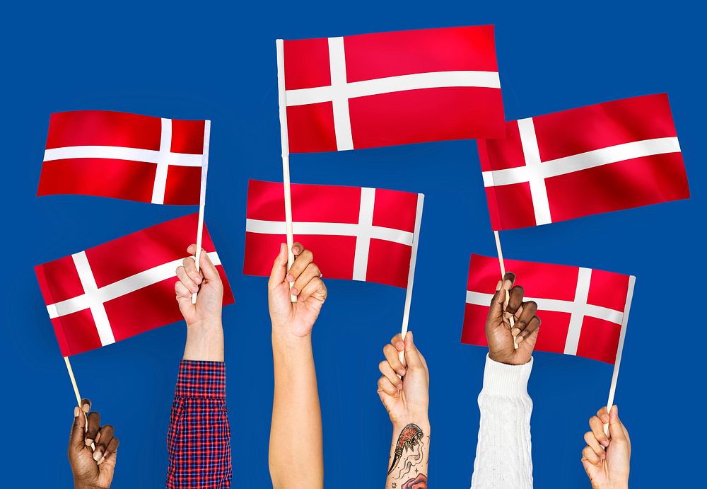 Hands waving the flags of Denmark