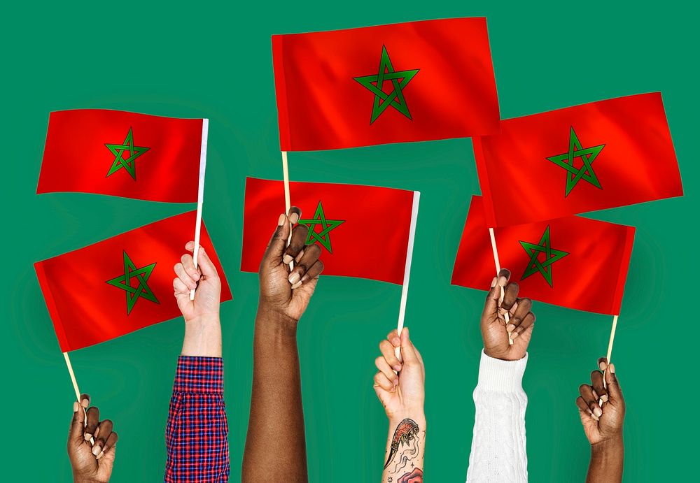 Hands waving the flags of Morocco