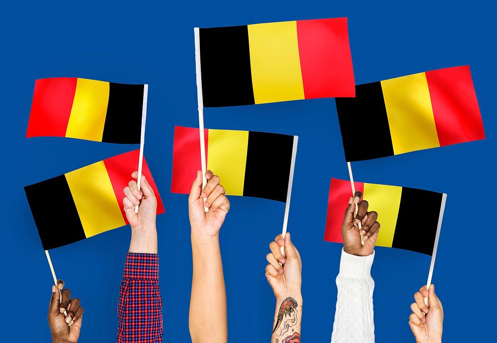 Hands waving the flags of Belgium