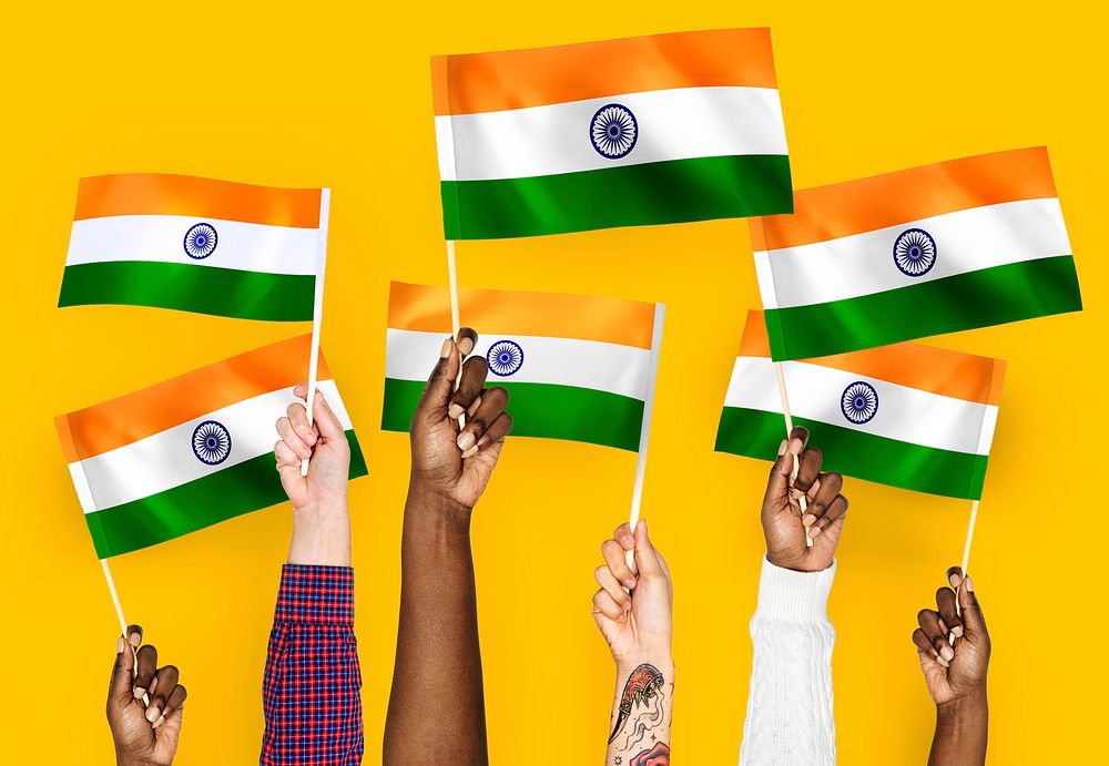 Hands waving flags of India