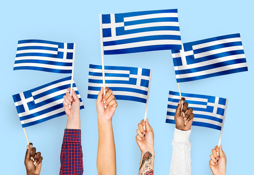 Hands waving flags of Greece
