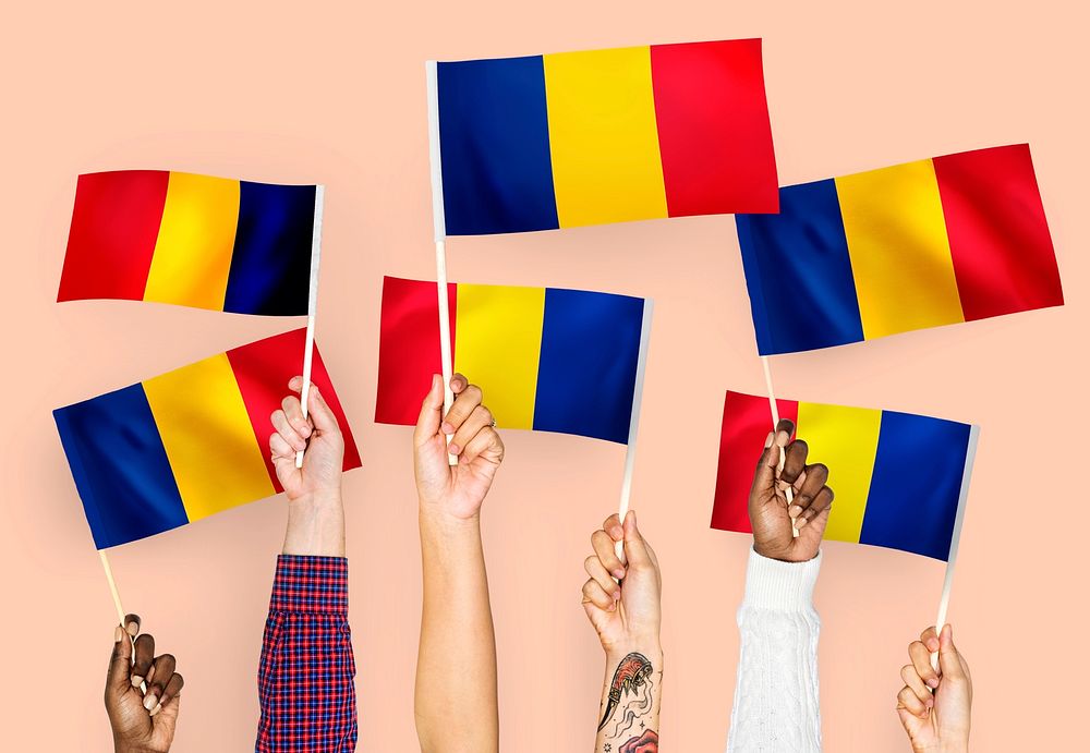 Hands waving flags of Romania