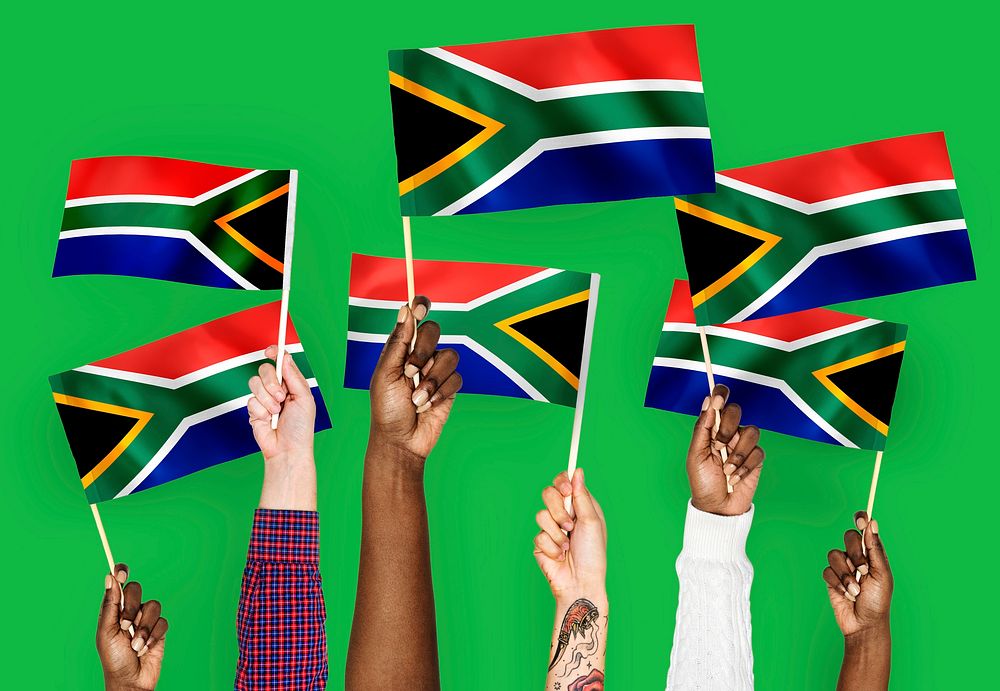 Hands waving flags of South Africa