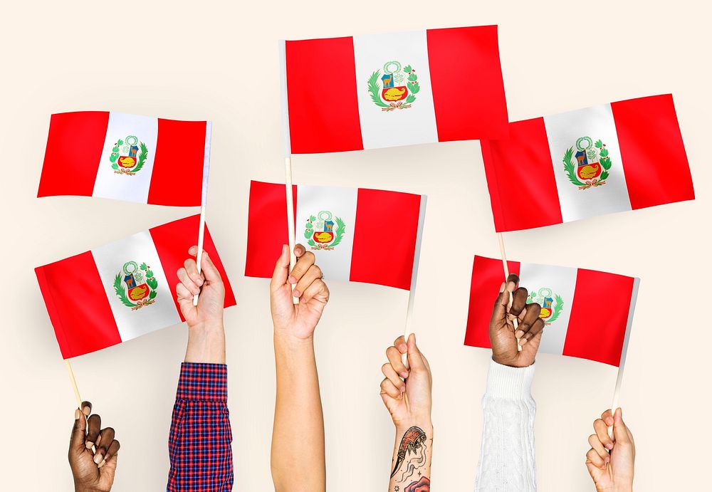 Hands waving the flags of Peru