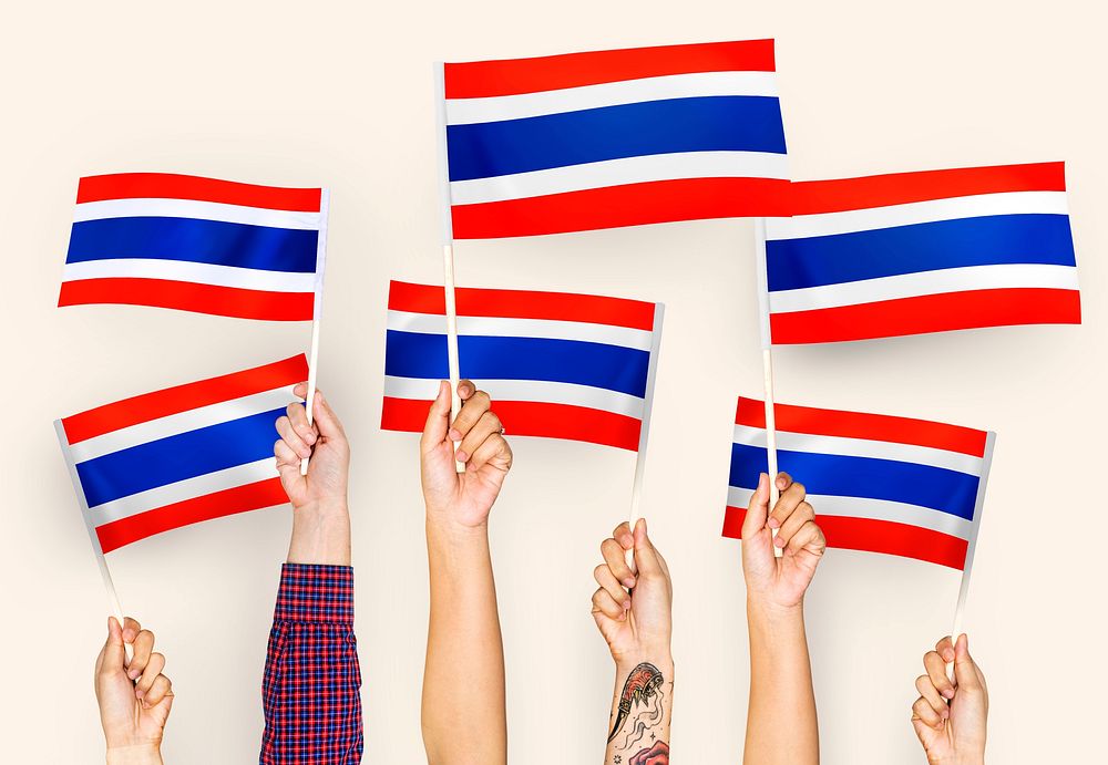 Hands waving flags of Thailand