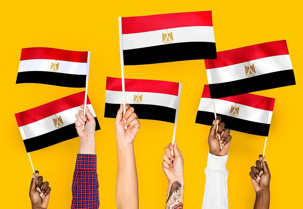 Hands waving the flags of Egypt