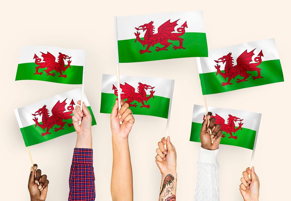Hands waving flags of Wales