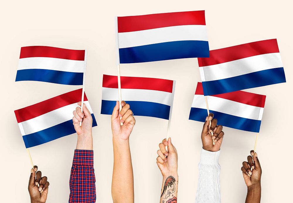 Hands waving flags of the Netherlands