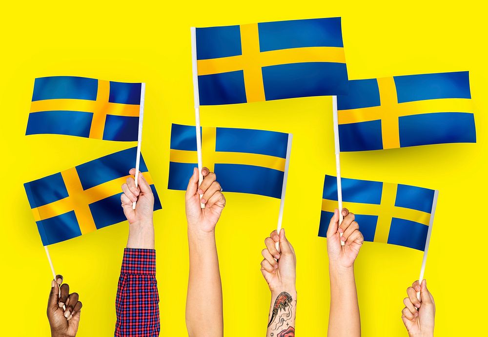 Hands waving the flags of Sweden