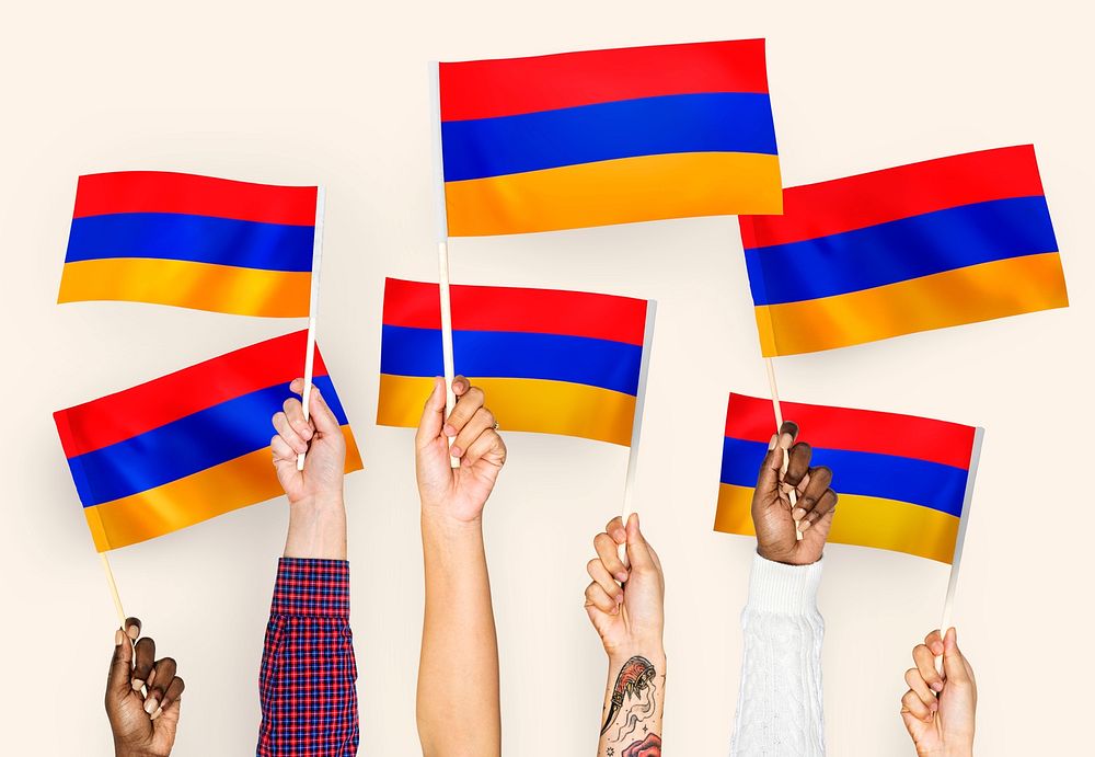 Hands waving flags of Armenia