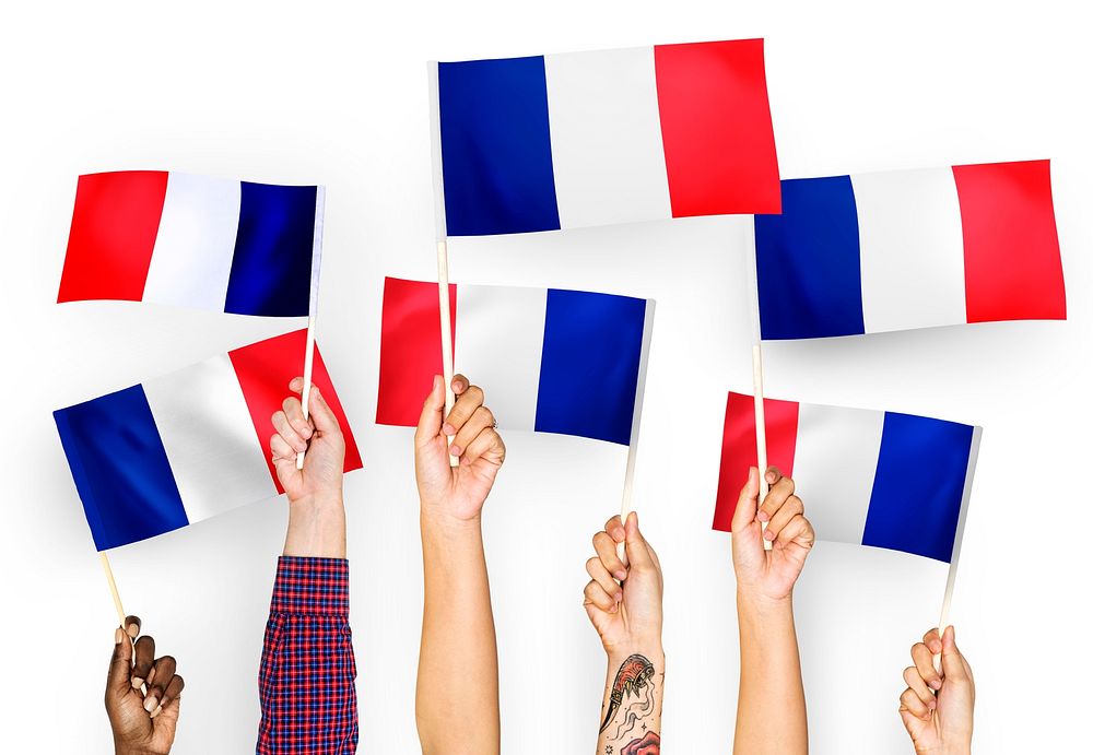 Hands waving the flags of France