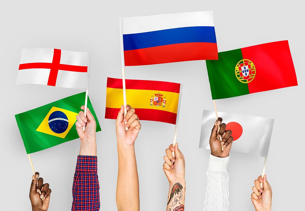 Hands raising national flags of England, Spain, Japan, Portugal, Russia, and Brazil