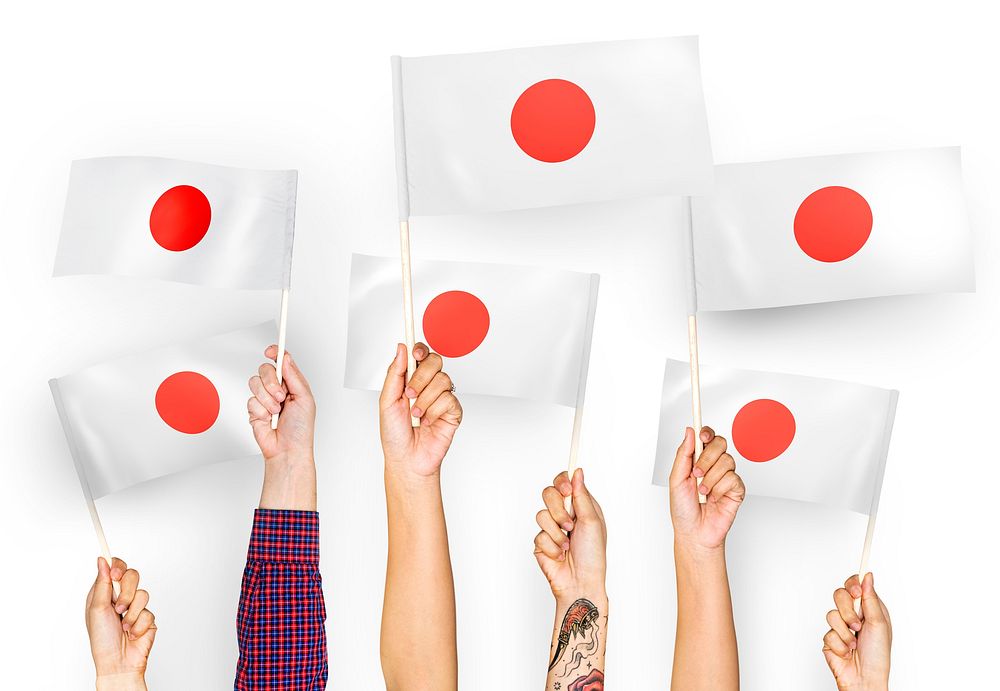 Hands waving the flags of Japan