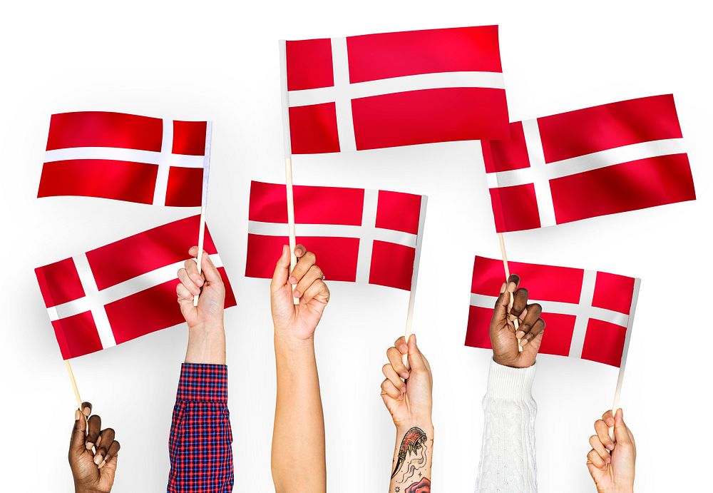 Hands waving the flags of Denmark