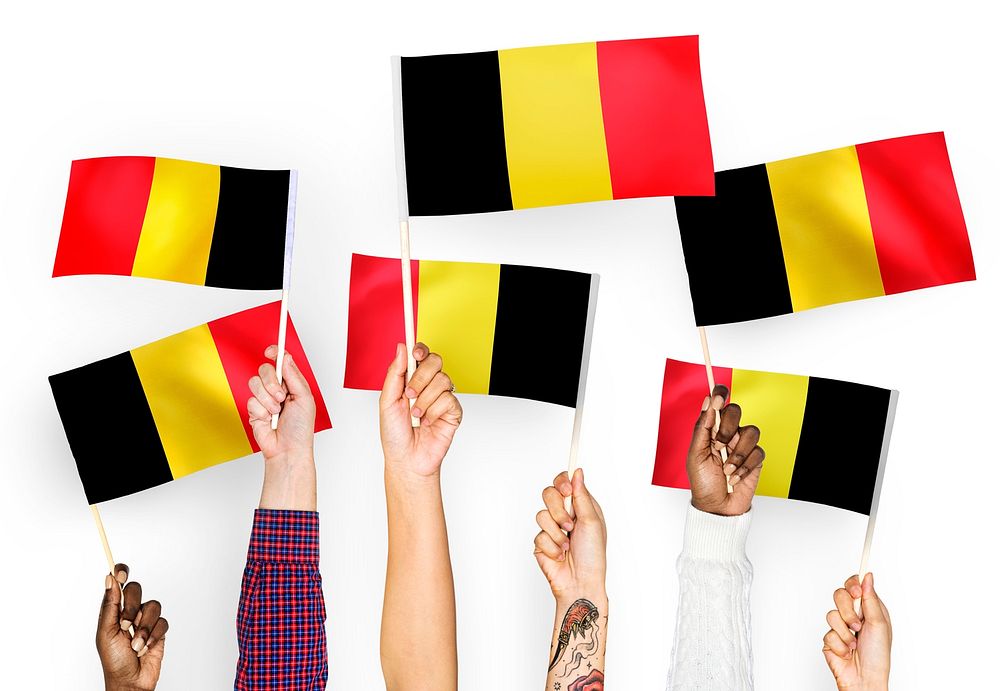 Hands waving the flags of Belgium