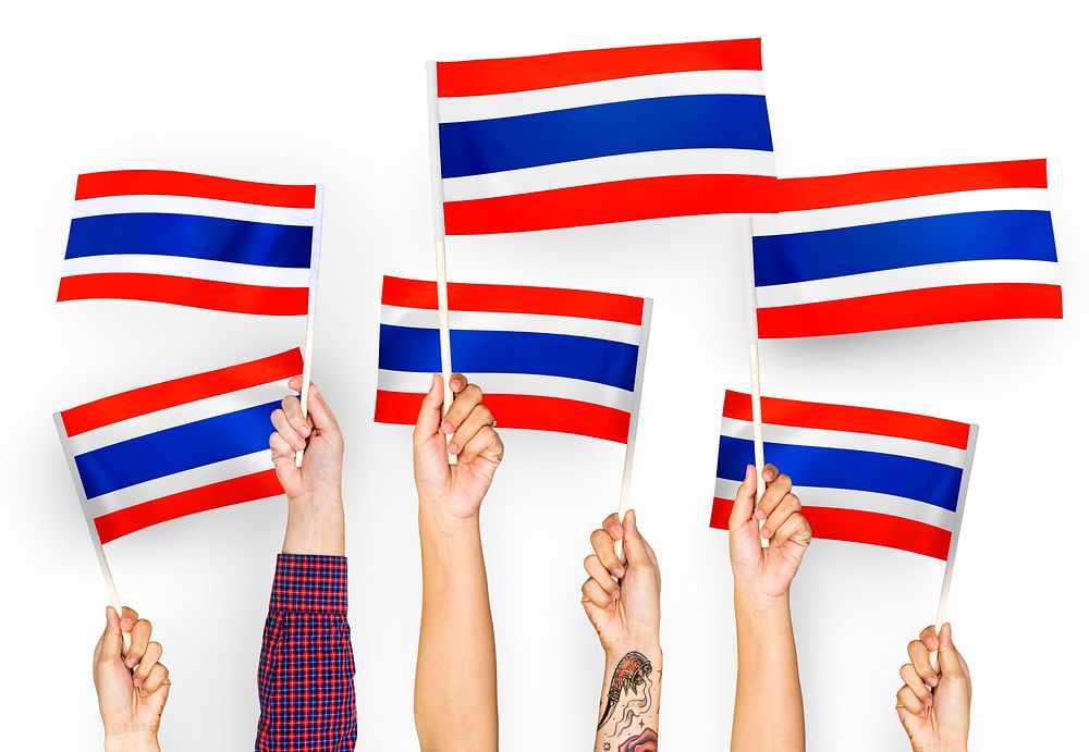 Hands waving flags of Thailand
