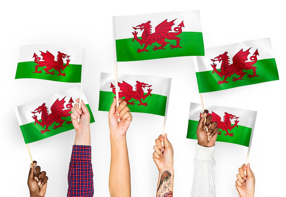 Hands waving flags of Wales