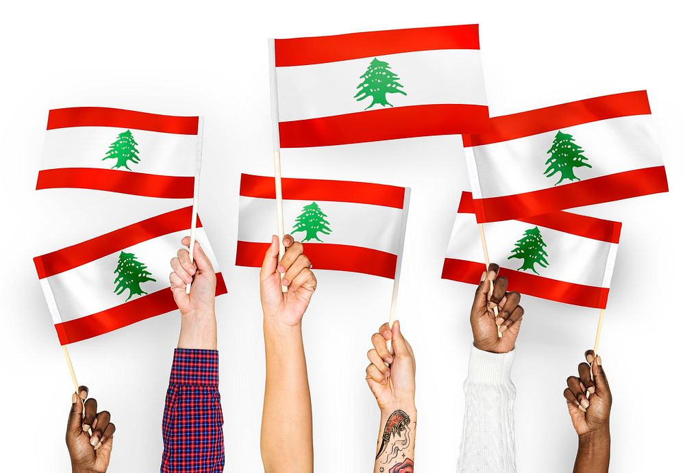 Hands waving flags of Lebanon