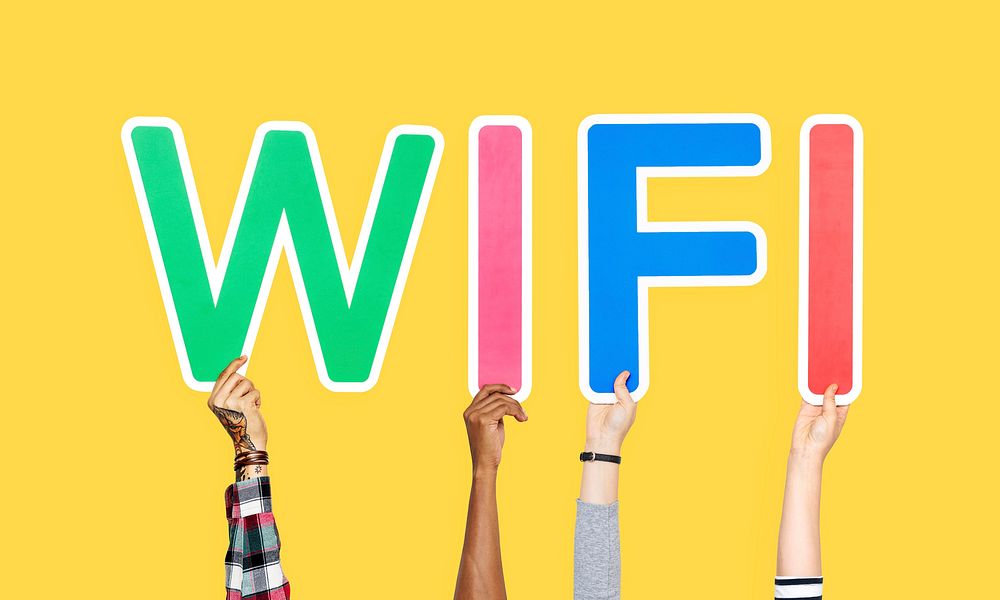 Hands holding up colorful letters forming the word wifi