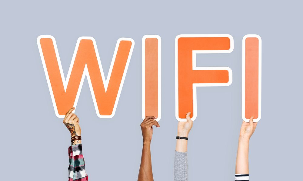 Hands holding up colorful letters forming the word wifi