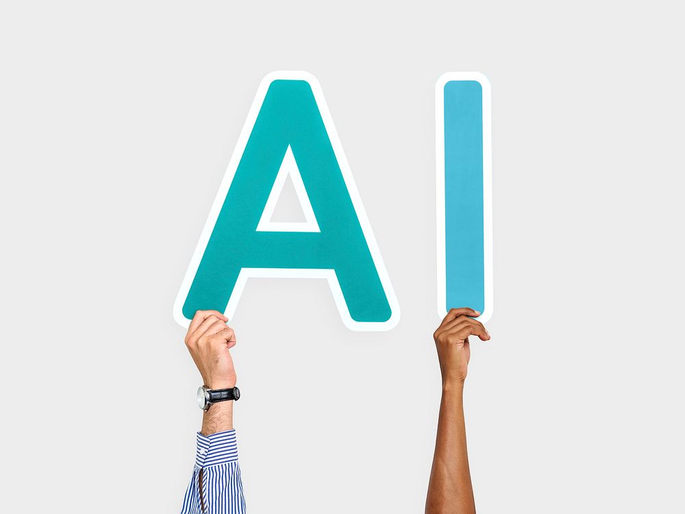 Hands holding up blue letters forming the abbreviation AI