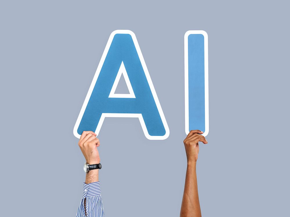 Hands holding up blue letters forming the abbreviation AI