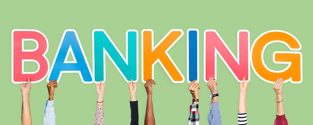 Hands holding up colorful letters forming the word banking
