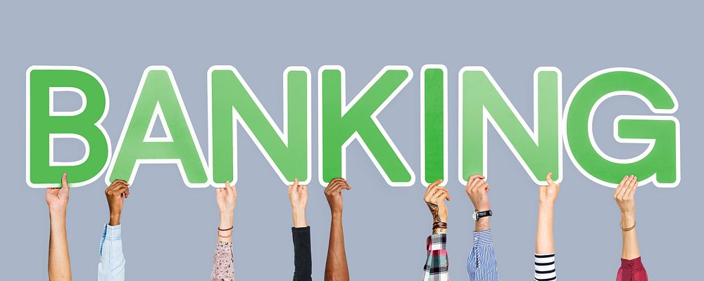 Hands holding up green letters forming the word banking