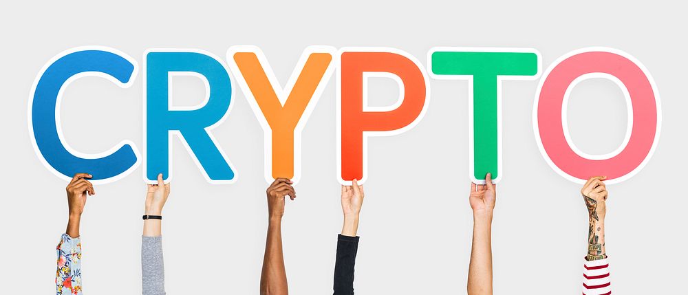 Hands holding up colorful letters forming the word crypto