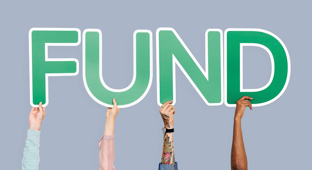 Hands holding up green letters forming the word fund
