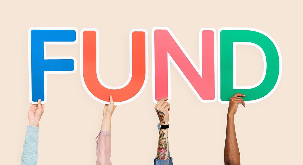 Hands holding up colorful letters forming the word fund