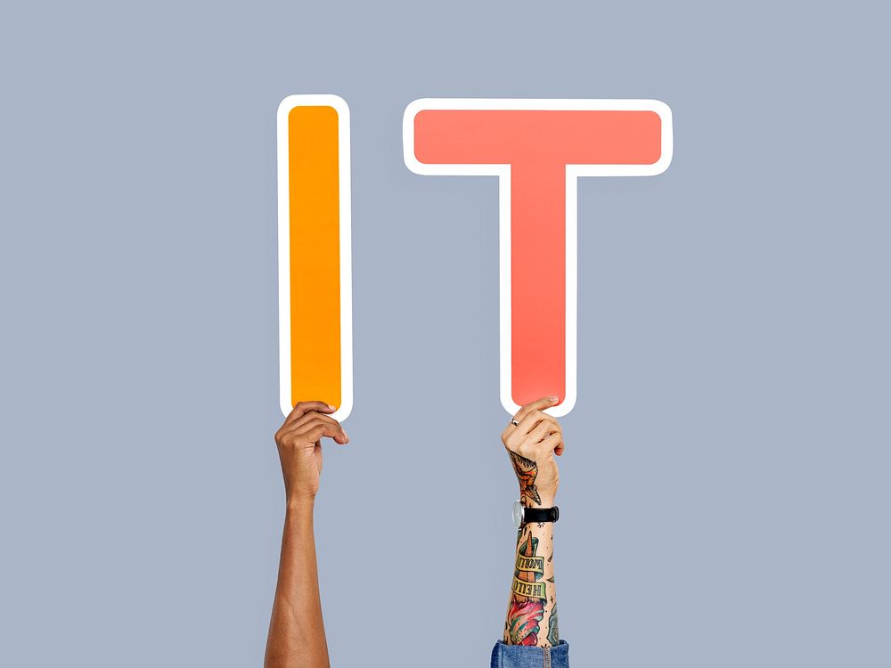 Hands holding up colorful letters forming the abbreviation IT