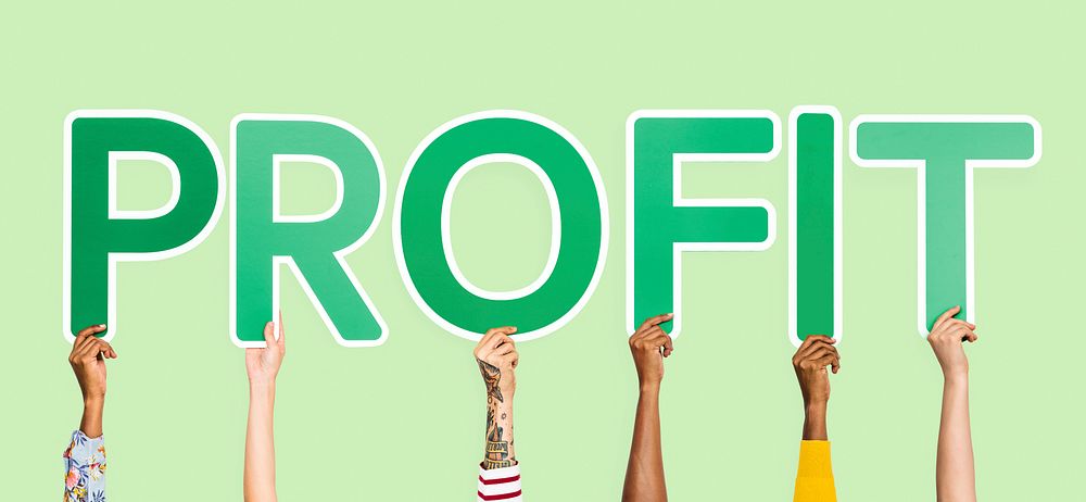 Hands holding up green letters forming the word profit