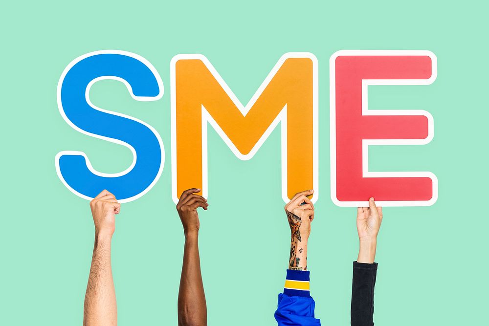 Hands holding up colorful letters forming the abbreviation SME