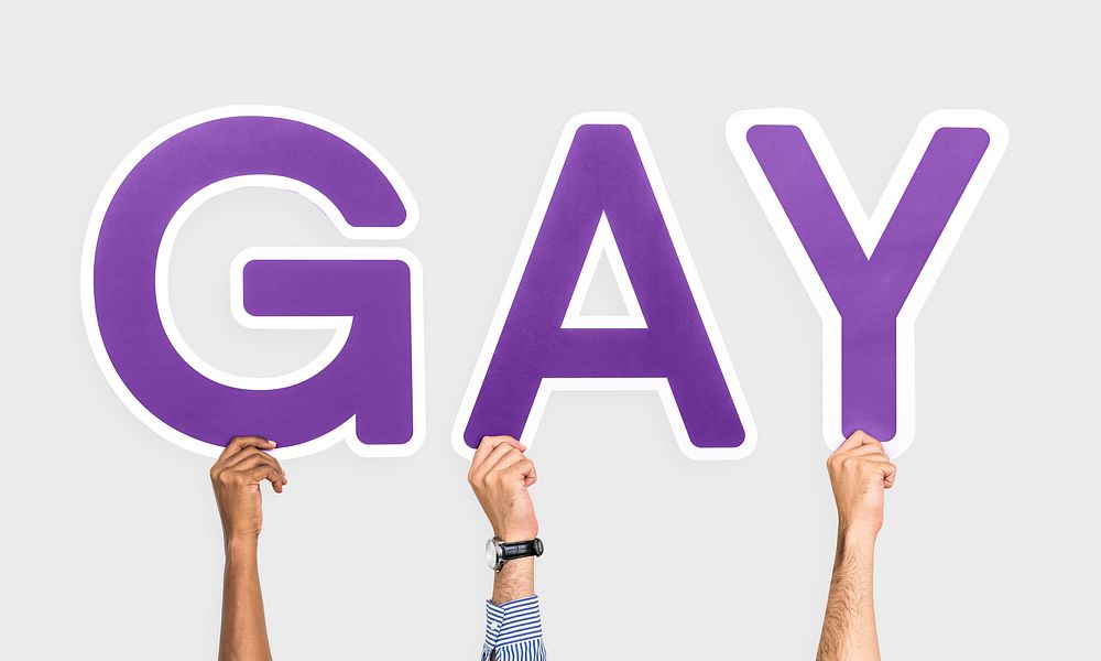 Hands holding the word Gay