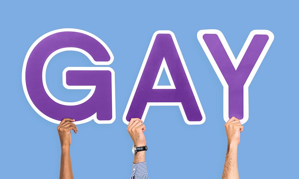 Hands holding the word Gay
