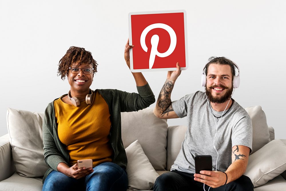 Couple showing a Pinterest icon