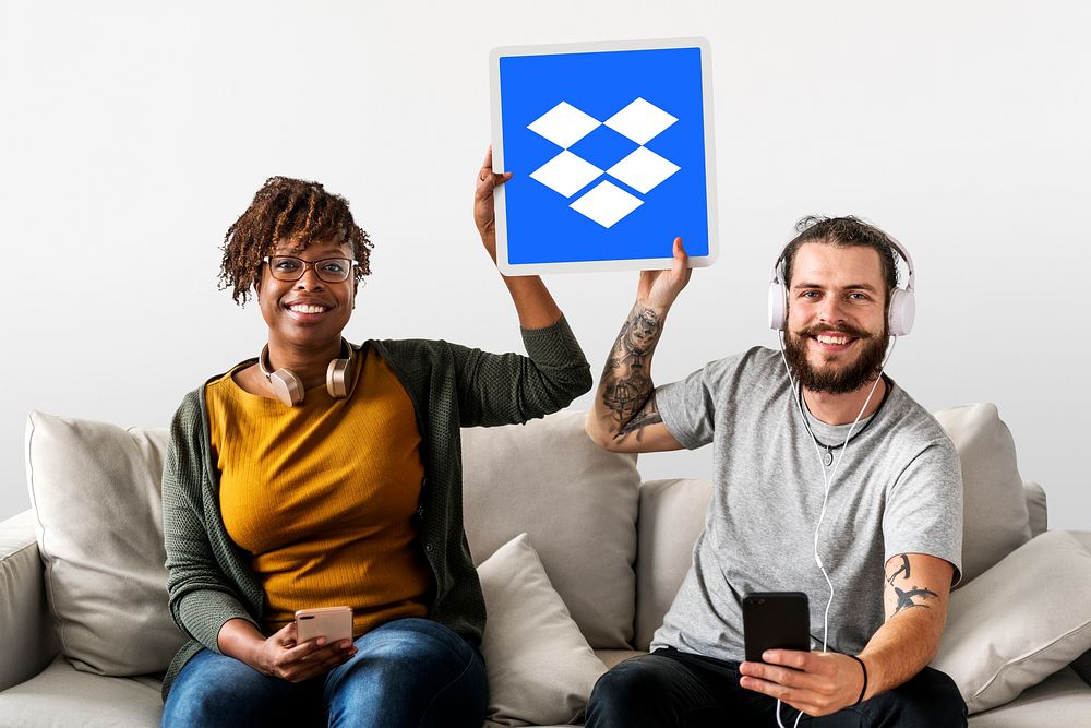 People holding up a Dropbox icon