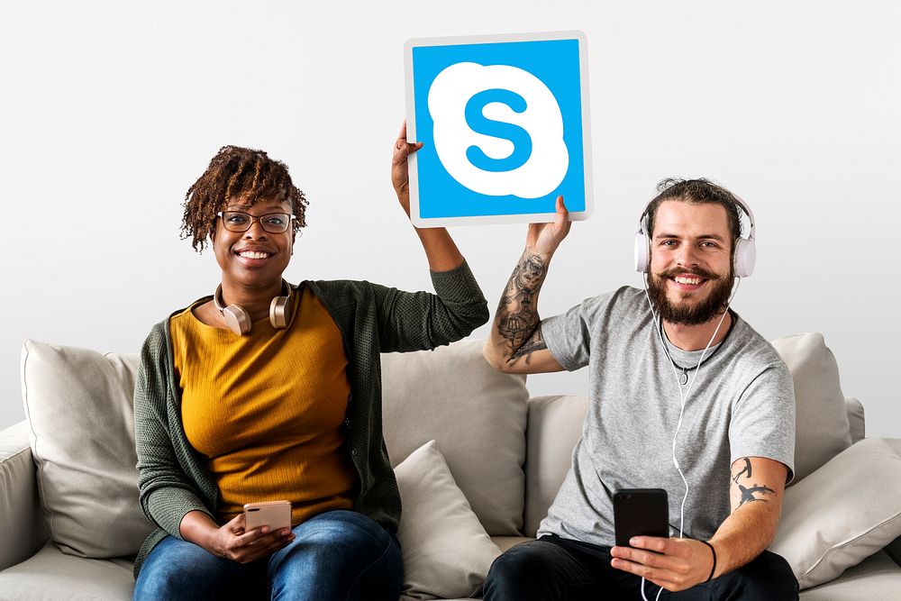 Couple showing a Skype icon