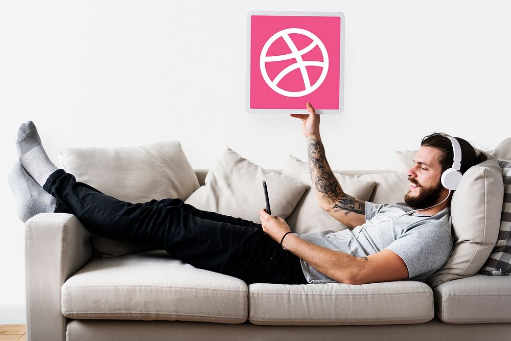 Man holding a Dribbble icon
